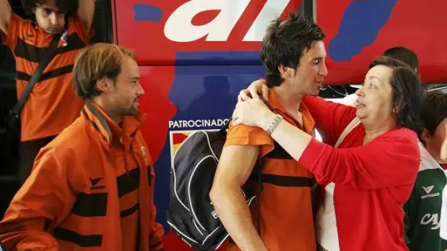 Joaquín Sorribas se saluda con una aficionada en el regreso del Huesca de tierras gallegas.