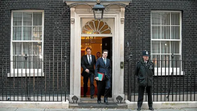 El ministro de Economía, George Osborne (d), y el secretario del Tesoro, Danny Alexander, salen del número 10 de Downing Street.
