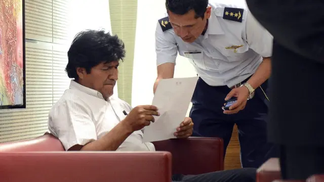 Evo Morales dialoga con un piloto en el aeropuerto de Viena