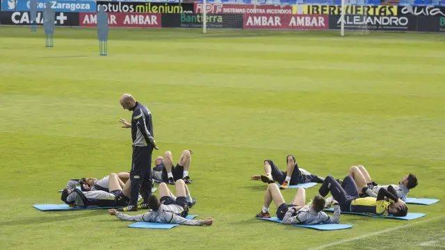 Ranko Popovic dialoga con varios jugadores mientras ejecutan ejercicios de estiramientos en el ensayo de La Romareda