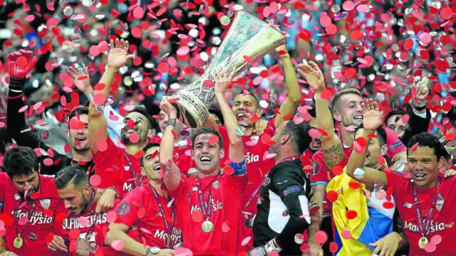 Fernando Navarro levanta la copa de la Europa League ante la euforia de sus compañeros.