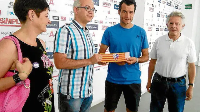 Obsequio de CHA al capitán Camacho recibió ayer de manos de los representantes de CHA en Huesca, -Sonia Alastruey, David Félez y Francho Nagore- un brazalete con los colores de Aragón y el escudo del Huesca.