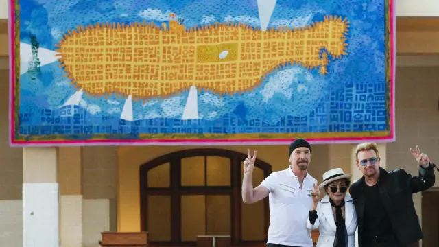 Yoko Ono, Bono y The Edge posan con el tapiz
