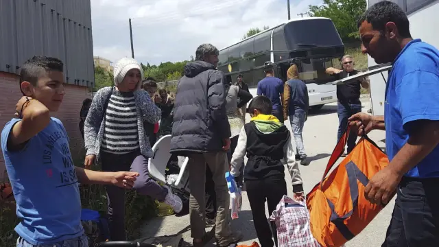 Varios refugiados a su llegada al centro de la ciudad Oreokastro, tras el desalojo del campamento de refugiados de Idomeni.