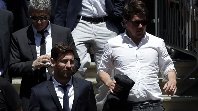 Messi, junto a su padre, a la salida del juicio