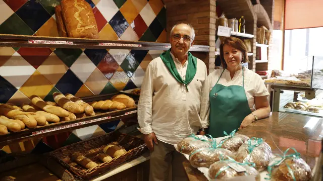 Santiago Ayerbe y Pilar Carrera, en el mostrador de la panadería que han regentado durante 55 años.