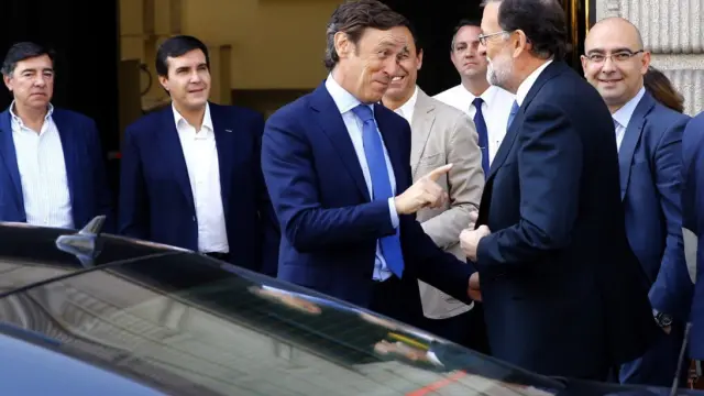 El presidente del PP y del Gobierno en funciones, Mariano Rajoy (2-d), conversa con el portavoz del partido, Rafael Hernando,