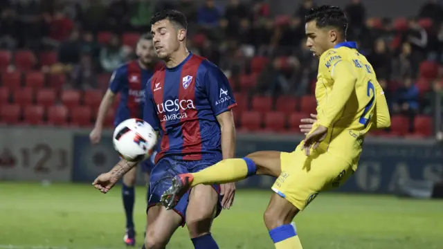 Kilian Grant, del Huesca, pelea un balón con un jugador rival.