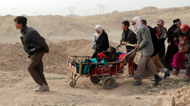 Un grupo de personas hoye de la ciudad de Mosul.