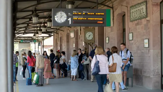 Viajeros en la estación de Teruel esperando ayer la llegada del tren de Zaragoza a Valencia.