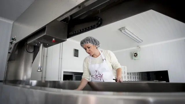 Lourdes Artal supervisa la maquinaria antes de comenzar la manufactura de sus quesos.