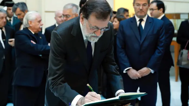 El presidente del gobierno Mariano Rajoy, firma el libro de condolencias en la capilla ardiente del fiscal general del Estado, José Manuel Maza.