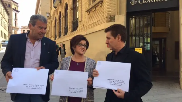 Los alcaldes de Berbegal, Peralta y Villanueva de Sijena con las cartas que van a remitir al Vaticano, delante de la sede de Correos de Huesca