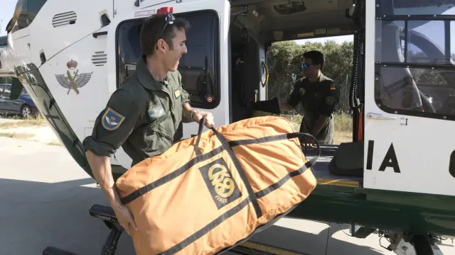 Especialistas de la Unidad Aérea colocando la camilla en el helicóptero con base en Huesca