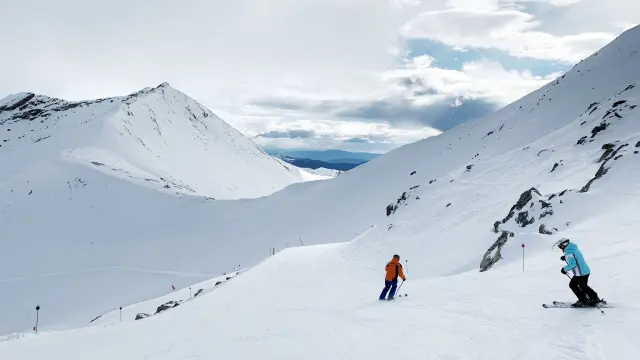 Primeros esquiadores deslizándose por la estación de Cerler
