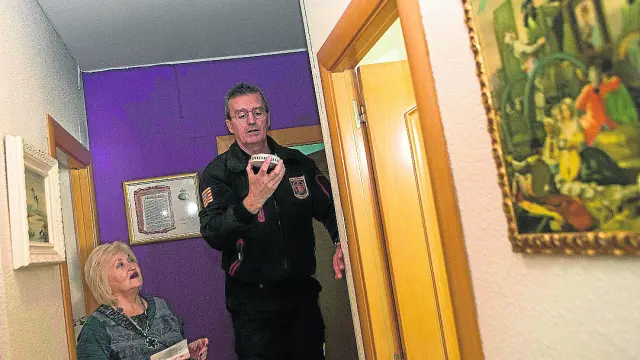 Carlos García, bombero del Museo de Fuego, explica a Soledad Lario el sistema de la alarma.
