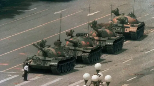 ** FILE ** A Chinese man stands alone to block a line of tanks heading east on Beijing's Changan Blvd. near Tiananmen Square in this June 5, 1989 file photo. Friday June 4, 2004 marks the 15th anniversary of the military crackdown on a student-led demonstration for democratic reform and against government corruption, which left hundreds, possibly thousands dead. (AP Photo/Jeff Widener, File)   CHINA TIANANMEN ANNIVERSARY