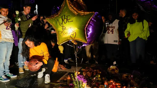 Mourners gather in Microsoft Square near the Staples Center to pay respects to Kobe Bryant after a helicopter crash killed the retired basketball star, in Los Angeles, California, U.S., January 26, 2020. REUTERS/Kyle Grillot [[[REUTERS VOCENTO]]] PEOPLE-KOBE BRYANT