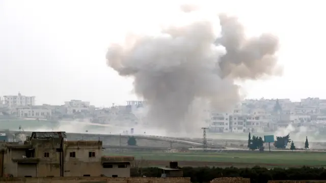 Smoke rises after an air strike in Saraqeb in Idlib province