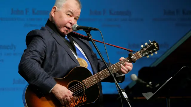 FILE PHOTO: Musician John Prine performs after accepting his PEN New England Song Lyrics of Literary Excellence Award during a ceremony at the John F. Kennedy Library in Boston
