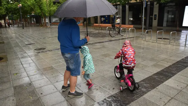 La lluvia también ha hecho acto de presencia en las calles de Huesca.