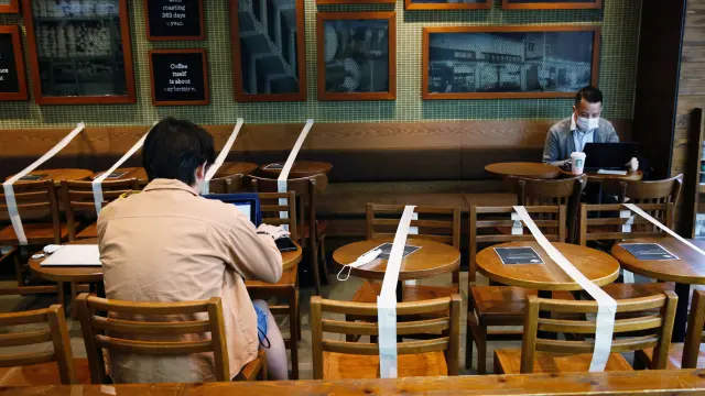 FILE PHOTO: Tables and chairs are taped up to keep social distancing at a Starbucks coffee shop, following the novel coronavirus disease (COVID-19) outbreak, in Hong Kong