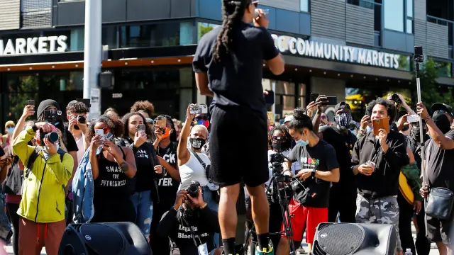 People gather against gentrification during the Fourth of July holiday in Seattle