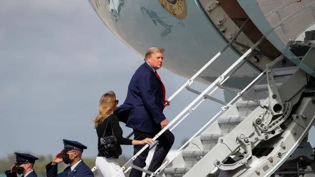 FILE PHOTO: U.S. President Donald Trump boards Air Force One with first lady Melania Trump at Palm Beach International Airport in Florida
