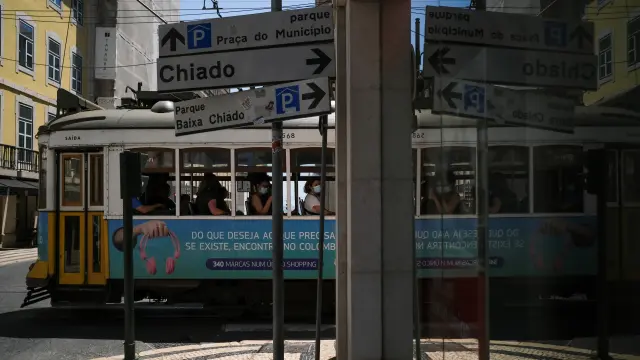 People sit inside a tram in downtown Lisbon amid the coronavirus disease (COVID-19) pandemic, in Lisbon