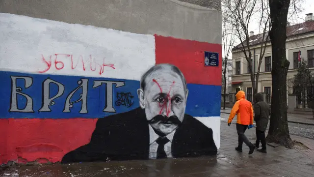 A mural of Russian President Vladimir Putin is vandalised, in Belgrade
