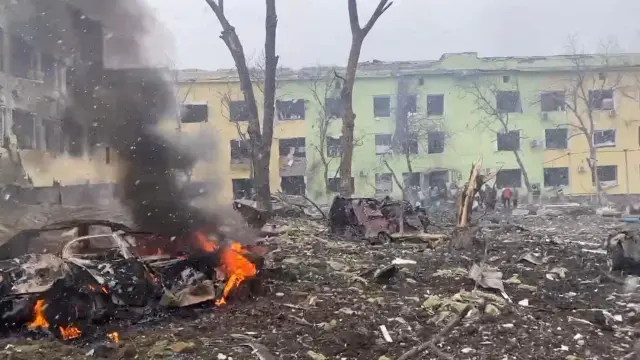 A view shows cars and a building of a hospital destroyed by air strike in Mariupol