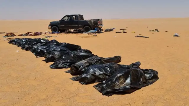 Security personnel recover bodies of migrants in the area between Kufra city and Chadian border