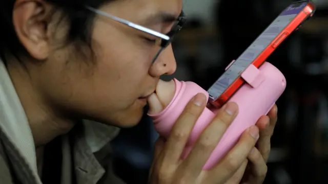Un usuario en Beijing utiliza el dispositivo chino para besar a distancia creado por Siweifushe.