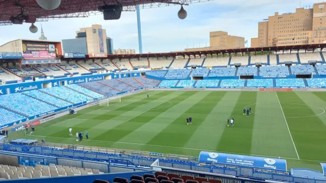 Los jugadores del Real Zaragoza y Las Palmas, hora y media antes del partido de este domingo, en La Romareda.