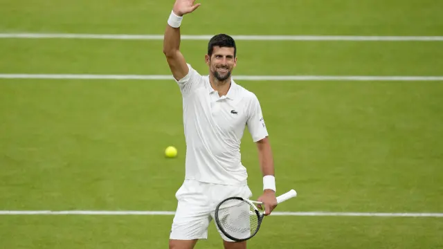 Serbia's Novak Djokovic reacts after beating Italy's Jannik Sinner to win their men's singles semifinal match on day twelve of the Wimbledon tennis championships in London, Friday, July 14, 2023. (AP Photo/Kirsty Wigglesworth)