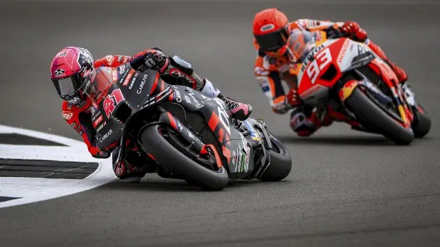 Aprilia Racing's Aleix Esparagro followed by Repsol Honda's Marc Marquez during Free Practice One ahead of the British Grand Prix 2023 at Silverstone, England, Friday Aug. 4, 2023. (Bradley Collyer/PA via AP)