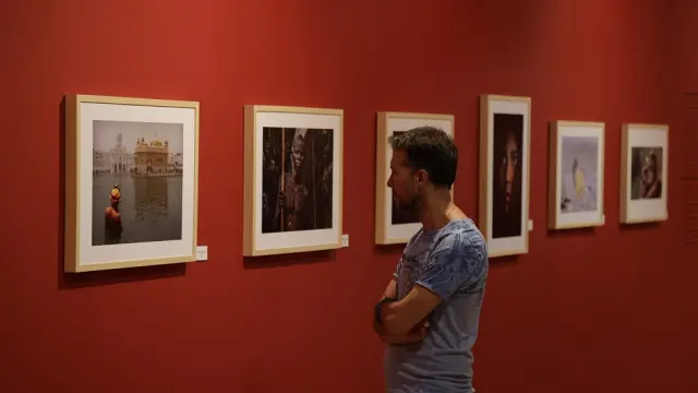Un visitante admira algunas de las fotografías expuestas en el Patio de la Infanta.