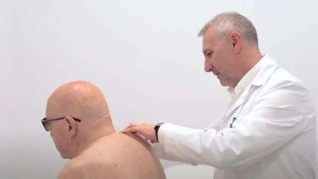 El doctor Carlos Jarabo inspecciona el hombro de Amadeo.
