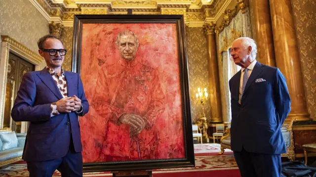 El artista Jonathan Yeo y Carlos III de Gran Bretaña en la inauguración del retrato del rey, en el salón azul del Palacio de Buckingham