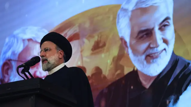 FILE - Iranian President Ebrahim Raisi addresses a ceremony marking anniversary of the death of the late Revolutionary Guard Gen. Qassem Soleimani, shown in the poster in background, who was killed in Iraq in a U.S. drone attack in 2020, at Imam Khomeini Grand Mosque in Tehran, Iran on Jan. 3, 2023. President Raisi, the country's foreign minister and others have been found dead at the site of a helicopter crash Monday, May 20, 2024, after an hourslong search through a foggy, mountainous region of the country's northwest, state media reported. (AP Photo/Vahid Salemi, File)