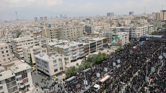 Mourners attend a funeral for victims of the helicopter crash that killed Irans President Ebrahim Raisi, Foreign Minister Hossein Amirabdollahian and others, in Tehran, Iran, May 22, 2024. Majid Asgaripour/WANA (West Asia News Agency) via REUTERS ATTENTION EDITORS - THIS PICTURE WAS PROVIDED BY A THIRD PARTY [[[REUTERS VOCENTO]]]