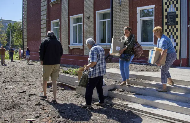 Locals receive humanitarian aid from Worldwide Food Program (WFP) in Kharkiv