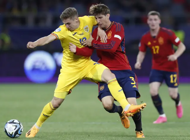 Louis Munteanu y Juan Miranda pugnan por un balón en el partido Rumanía-España del Europeo sub-21
