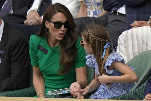 Kate, Princess of Wales chats with Princess Charlotte as they sit in the Royal Box on Centre Court for the final of the men's singles between Spain's Carlos Alcaraz and Serbia's Novak Djokovic on day fourteen of the Wimbledon tennis championships in London, Sunday, July 16, 2023. (AP Photo/Alastair Grant)