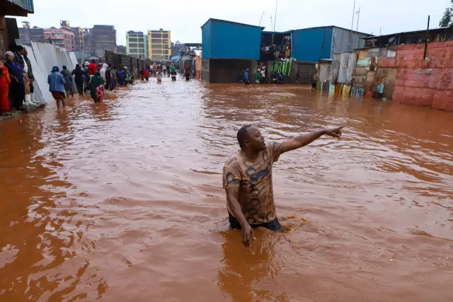 NAIROBI, April 24, 2024 -- A man reacts as he walks through floodwater after heavy rains in the Mathare slums of Nairobi, Kenya, on April 24, 2024. Kenya is experiencing heavy rains that have disrupted normal business across the East African country, resulting in the loss of more than 38 lives and the destruction of property...24/04/2024 [[[EP]]]