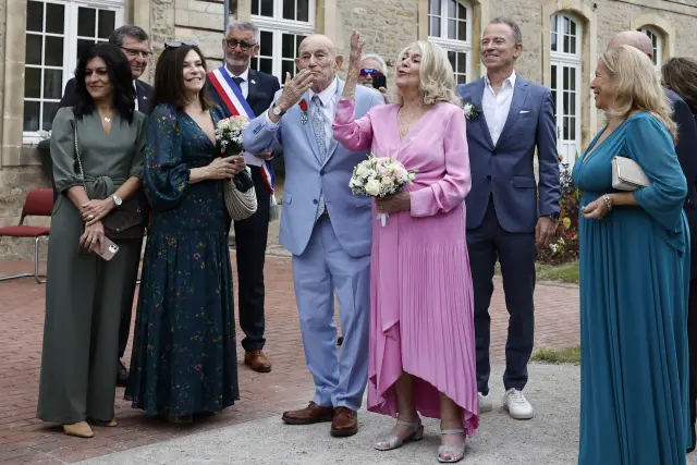 US WWII veteran Harold Terens, 100, center left, and Jeanne Swerlin, 96, arrive to celebrate their wedding at the town hall of Carentan-les-Marais, in Normandy, northwestern France, on Saturday, June 8, 2024. Together, the collective age of the bride and groom was nearly 200. But Terens and his sweetheart Jeanne Swerlin proved that love is eternal as they tied the knot Saturday inland of the D-Day beaches in Normandy, France. (AP Photo/Jeremias Gonzalez)