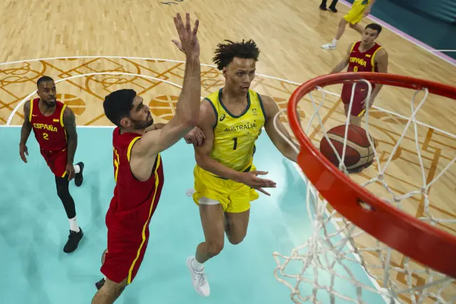 Dyson Daniels, of Australia, shoots around Santi Aldama, of Spain, in a men's basketball game at the 2024 Summer Olympics, Saturday, July 27, 2024, in Lille, France. (Gregory Shamus/Pool Photo via AP)