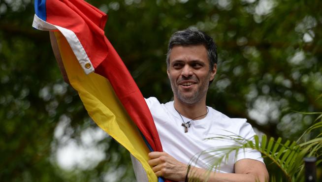 Venezuelan opposition leader Leopoldo Lopez displaying a Venezuelan national flag, greets supporters gathering outside his house in Caracas, after he was released from prison and placed under house arrest for health reasons, on July 8, 2017.Venezuela's Supreme Court confirmed on its Twitter account it had ordered Lopez to be moved to house arrest, calling it a "humanitarian measure" granted on July 7 by the court's president Maikel Moreno. "Leopoldo Lopez is at his home in Caracas with (wife) Lilian and his children," Lopez's Spanish lawyer Javier Cremades said in Madrid. "He is not yet free but under house arrest. He was released at dawn." / AFP PHOTO / Federico PARRA [[[AFP]]] VENEZUELA-CRISIS-OPPOSITION-LOPEZ-HOUSE ARREST