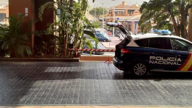 A Spanish National Police car is parked outside a hotel under lockdown after a coronavirus case was identified in Adeje