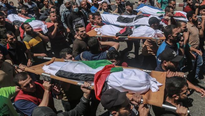Palestinos portan los cuerpos sin vida de la familia palestina muerta en bombardeos de Israel.